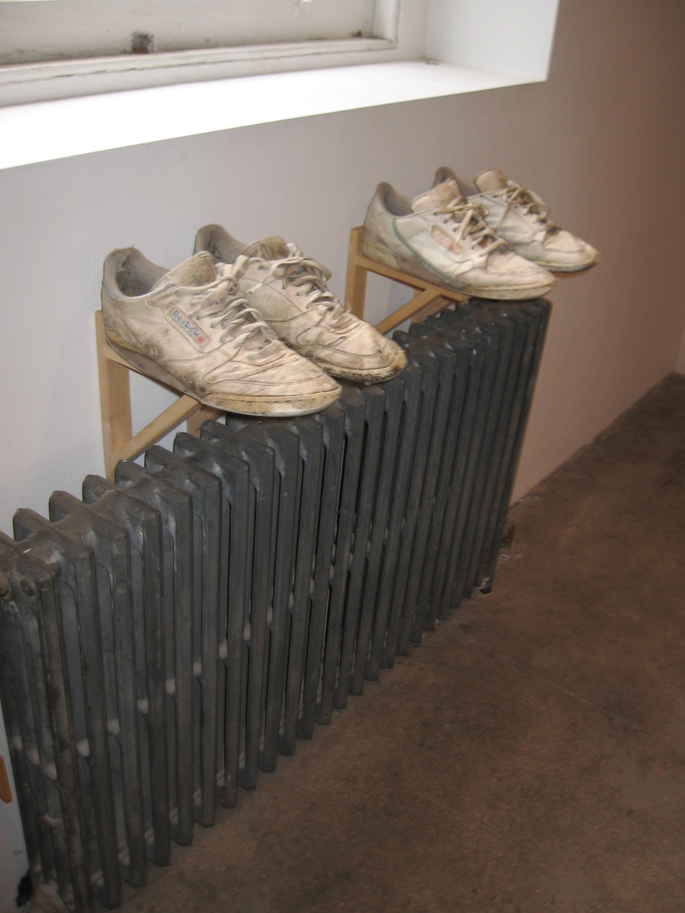 closeup of artist shoes displayed beneath window