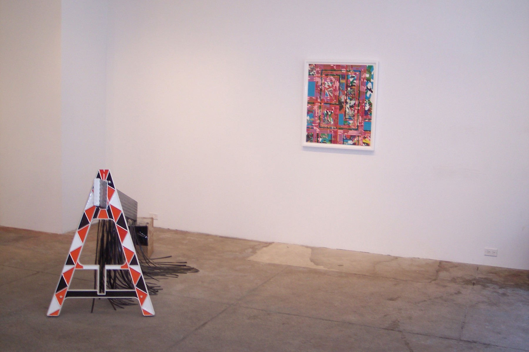 Gallery view of framed artwork and police barrier