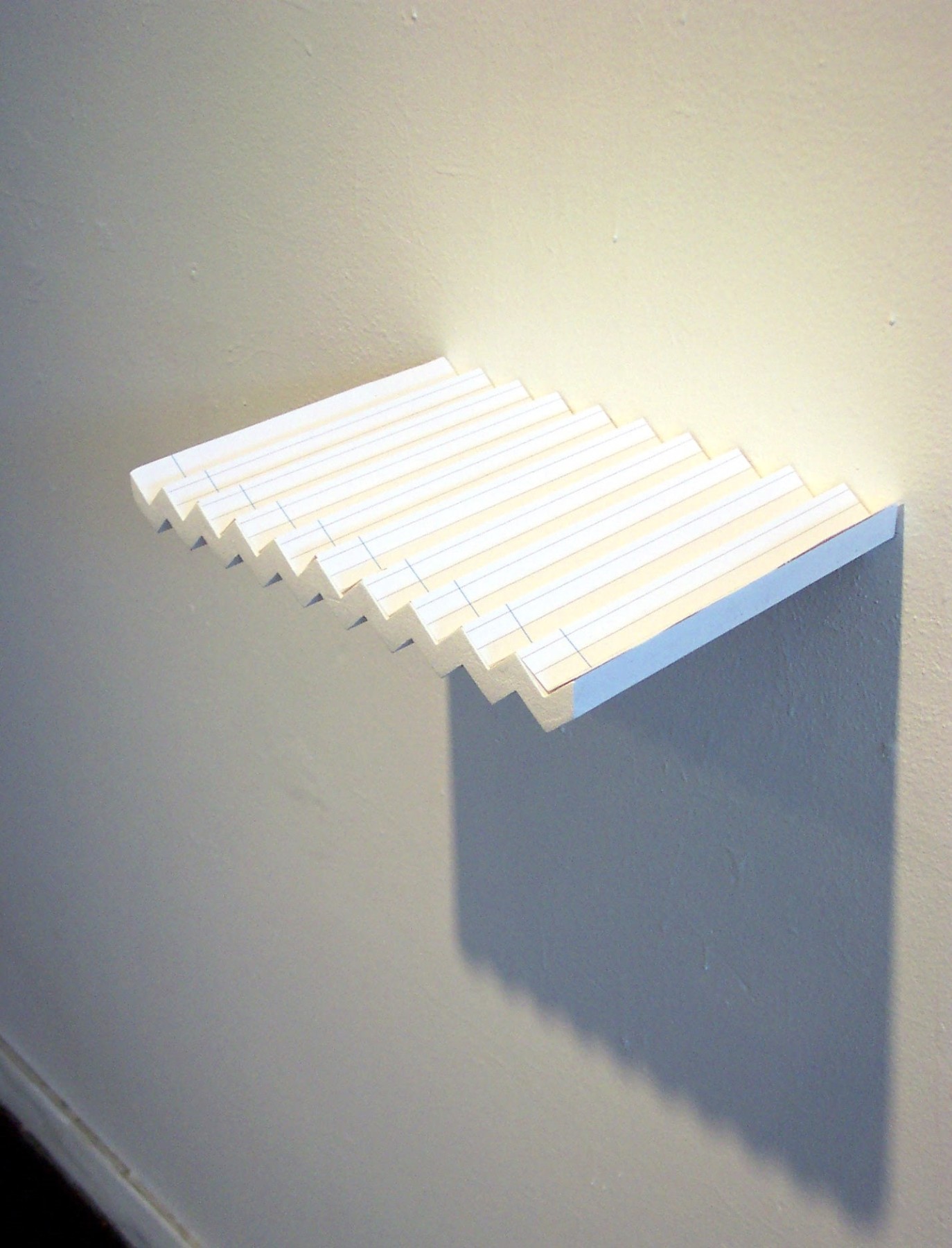 Folded shelf on gallery wall