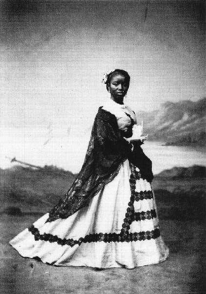 Black and white postcard of woman standing