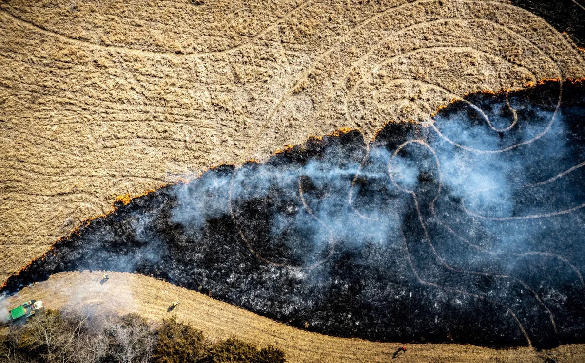 overhead photograph of a crop field with labyrinth and burn marks