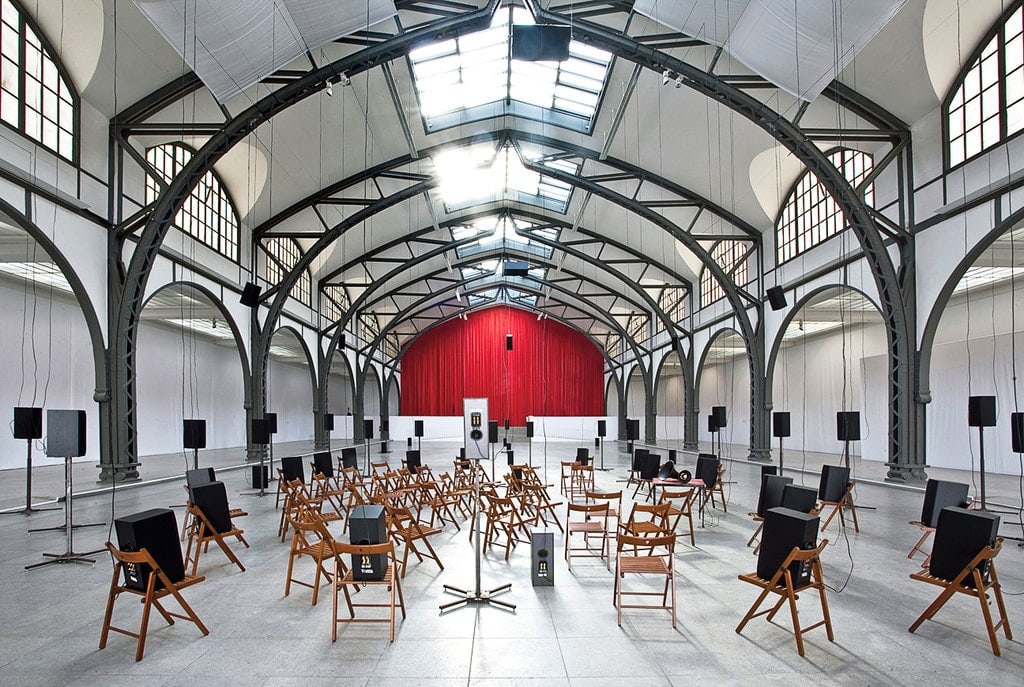 Large room with chairs and speakers