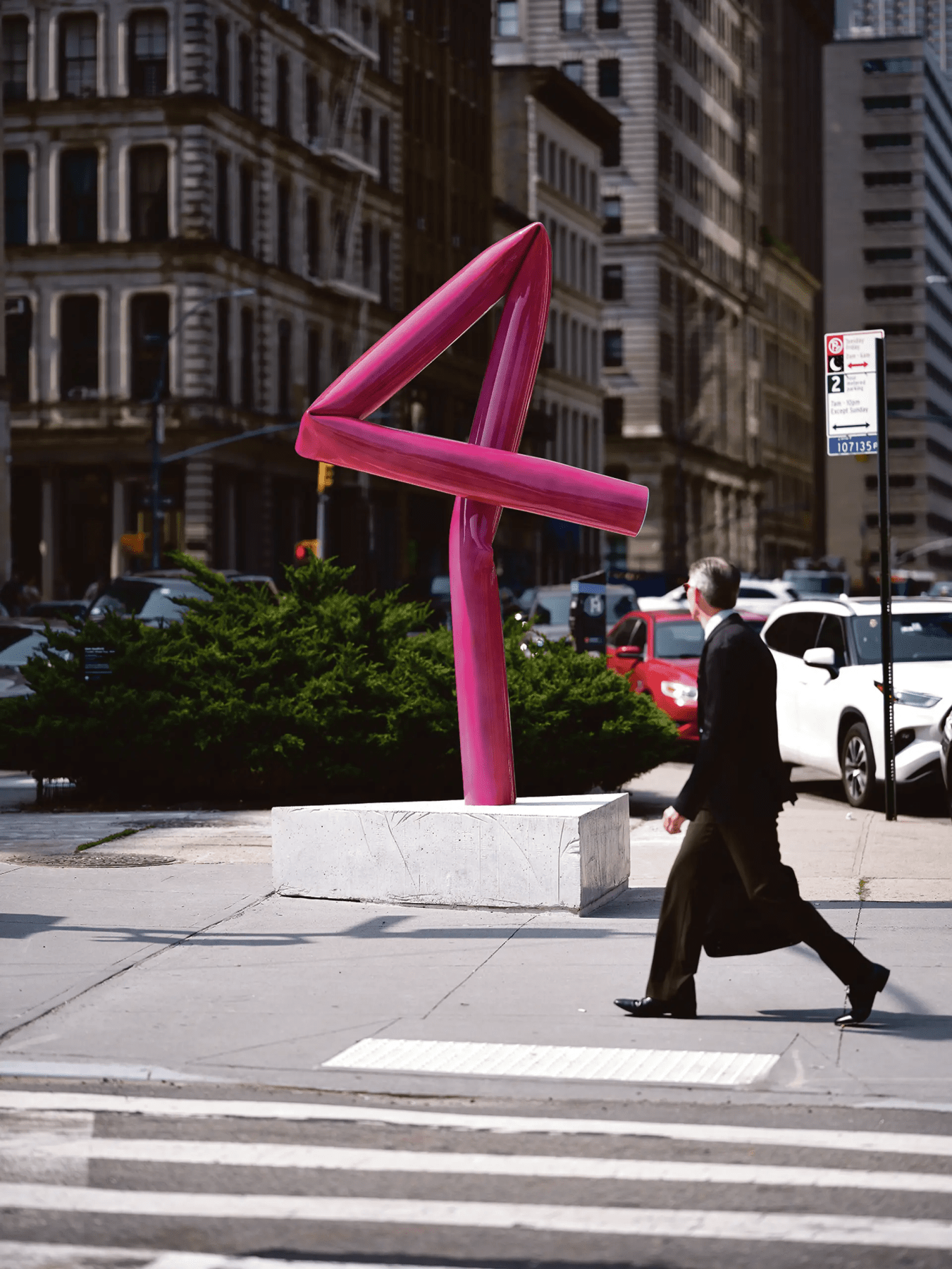 Hot pink metal sculpture twisted into the number 4
