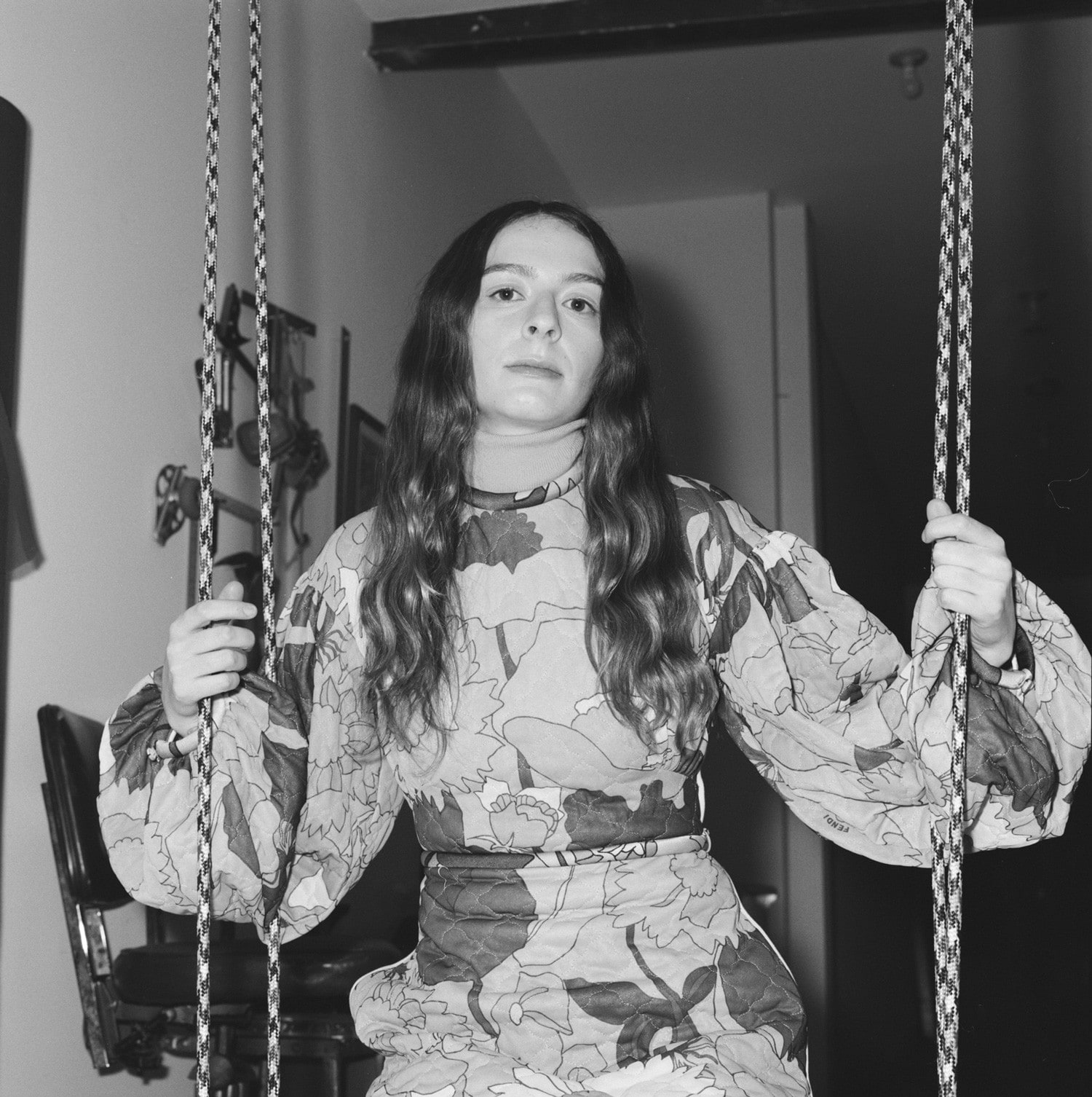 Woman with long hair sitting on a swing