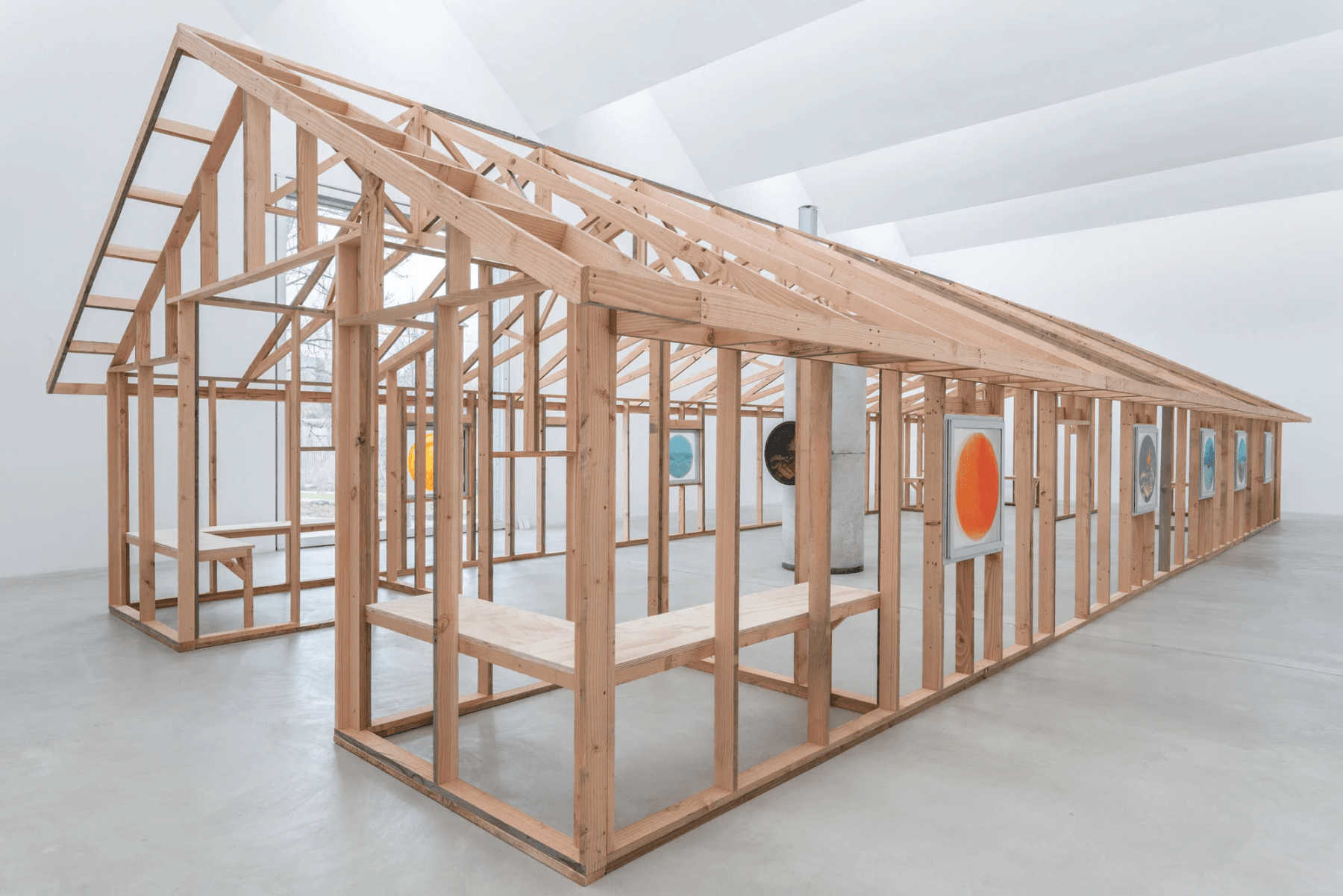 Gallery installation of the frames of a building with pitched roof