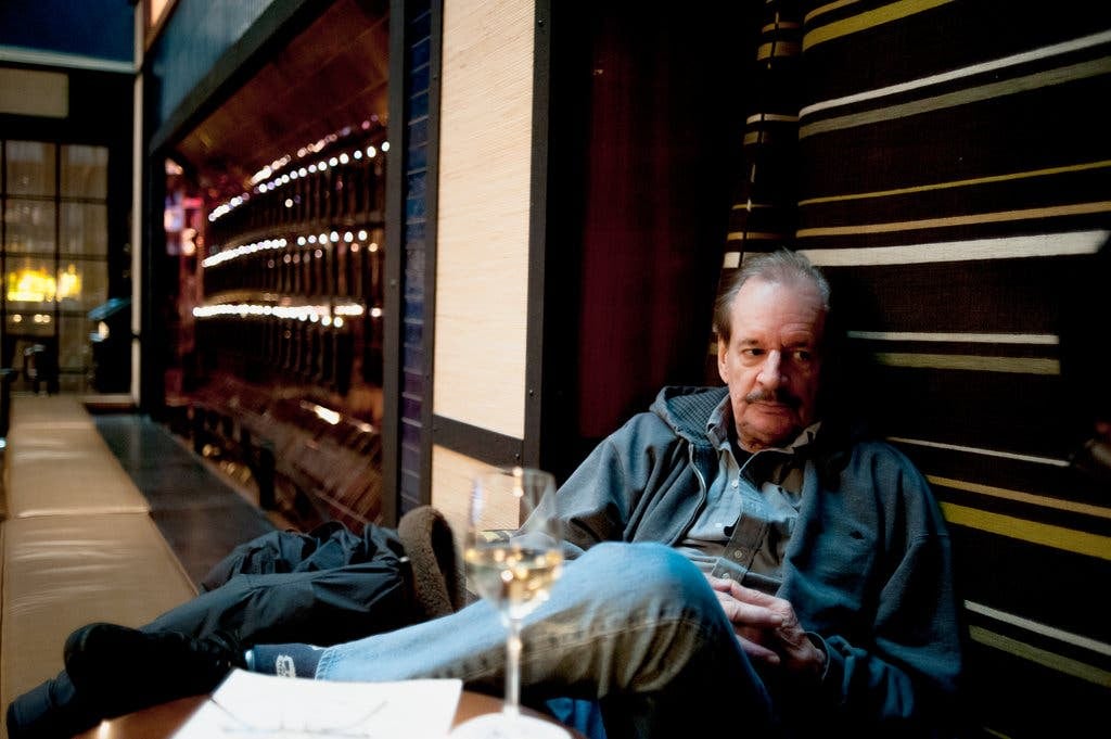 Larry Clark sitting at a table in Paris