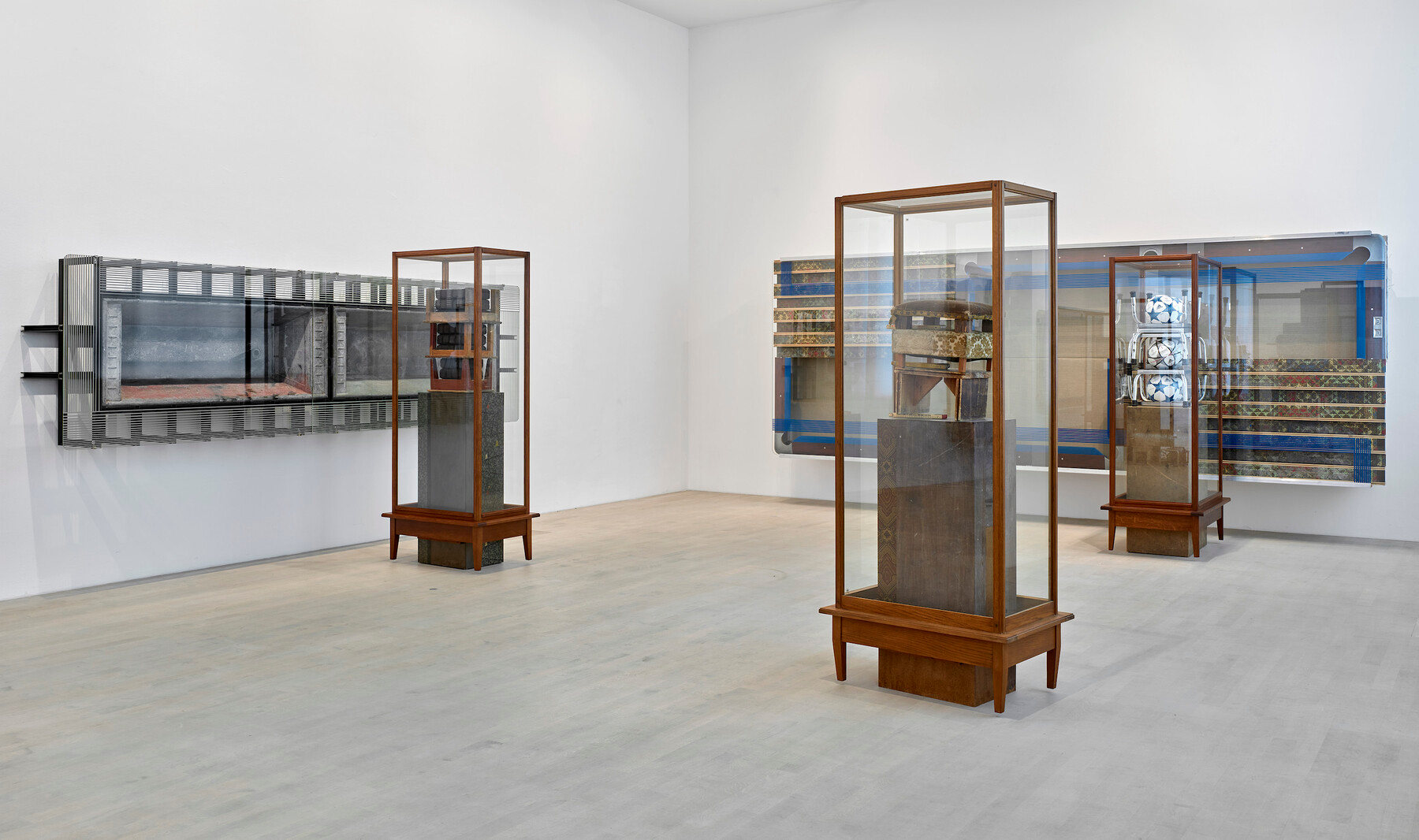 Gallery installation of sculpture in glass vitrines