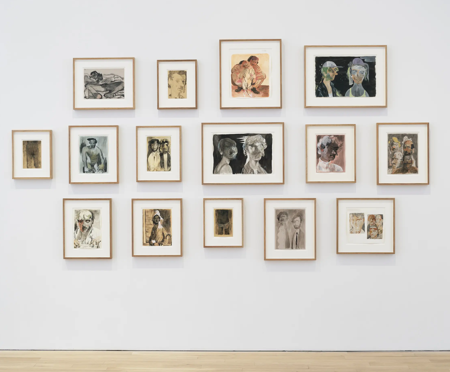 15 framed figure drawings hung on a gallery wall