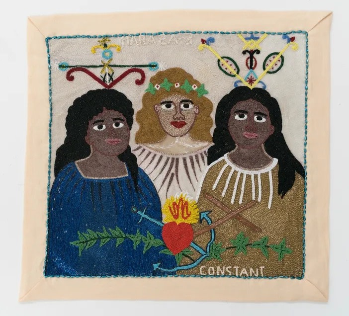 Beaded flag depicting 3 women and Vodou symbols