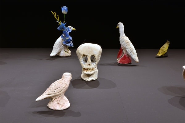 ceramic sculptures of a skull and 4 birds