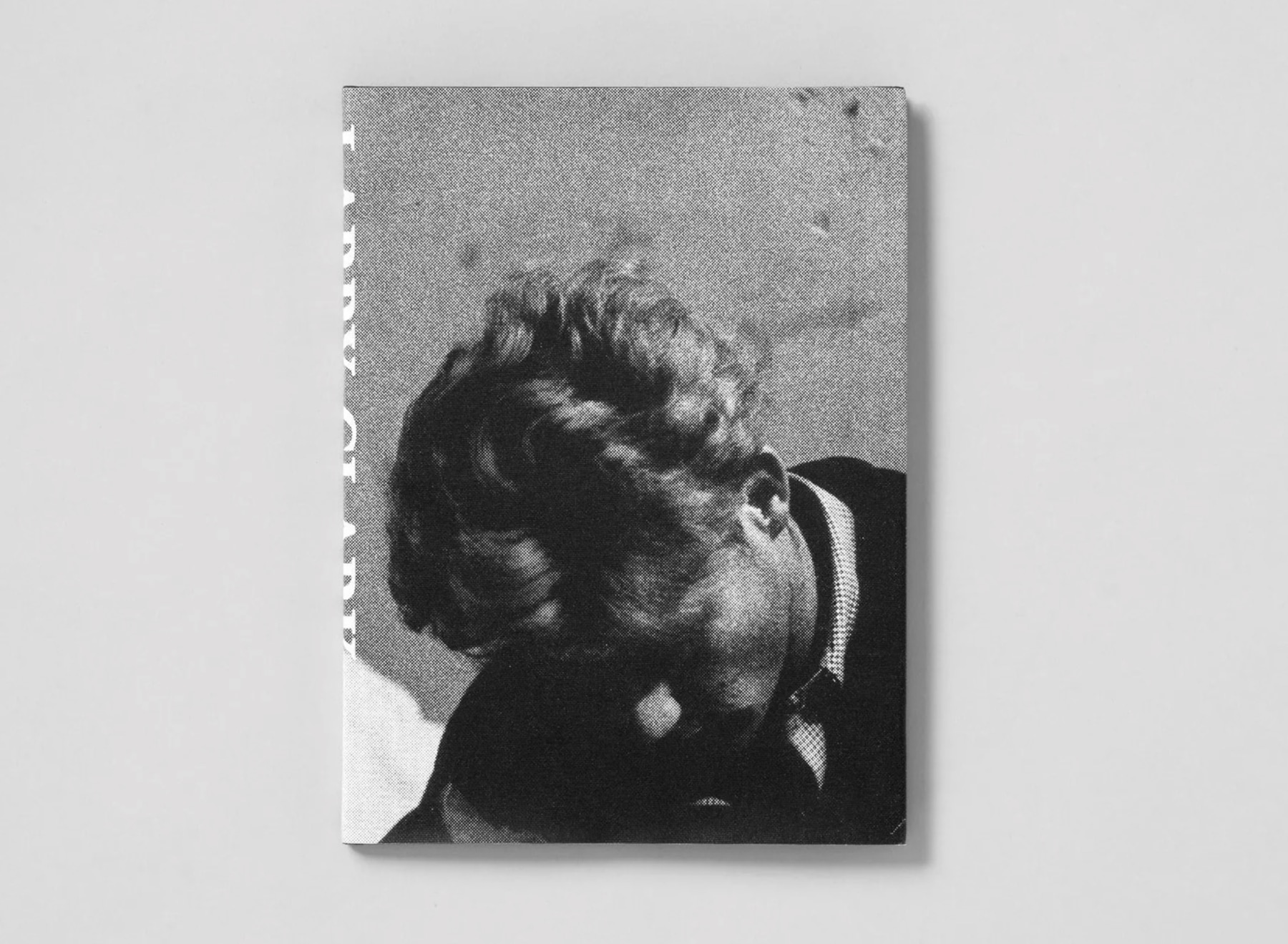 Cover of Larry Clark book: black and white photograph of a young man looking down