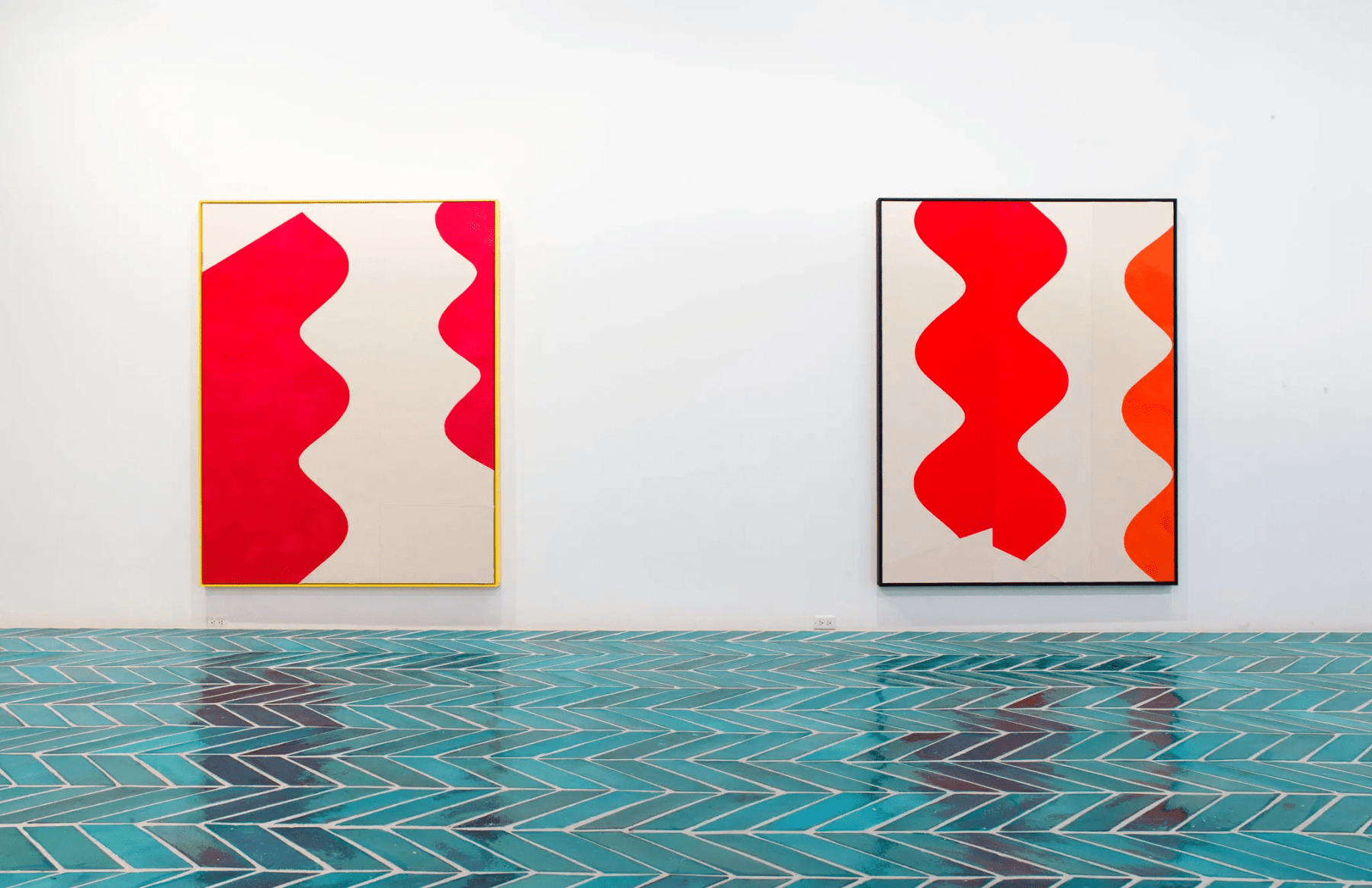 2 paintings in a gallery space with turquoise tiled floor