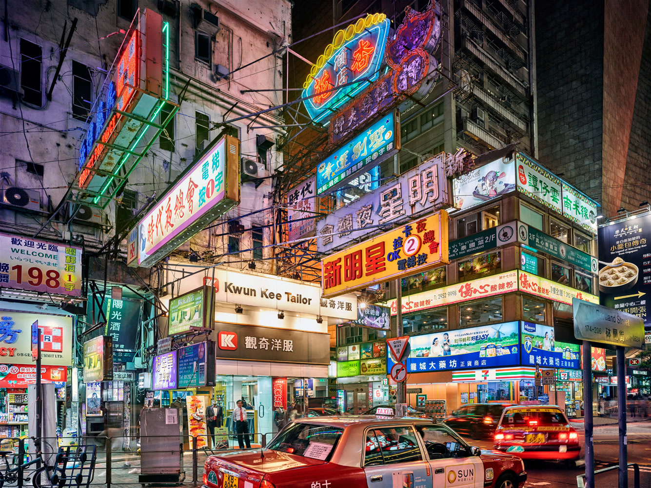 Color photo of a Tokyo street covered in neon signage.