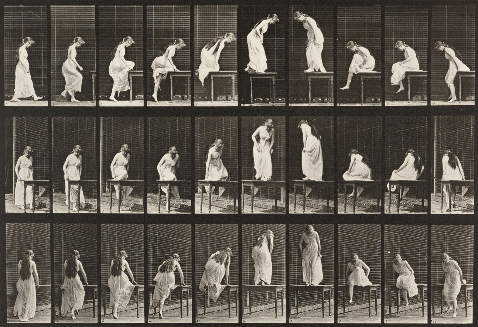 Sequence of black and white photos showing the movements of a woman with long hair in a dress getting on and off of a table
