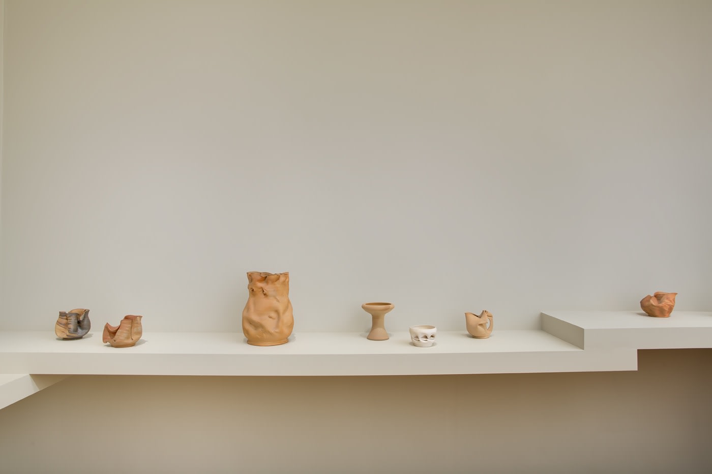 Installation view of George Ohr Pottery: No Two Alike on view at Craig F. Starr Gallery