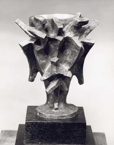 Black and white photo of a sculpted ceremonial cup. The exterior of the cup is made of various abstract attachments of different shapes and sizes.