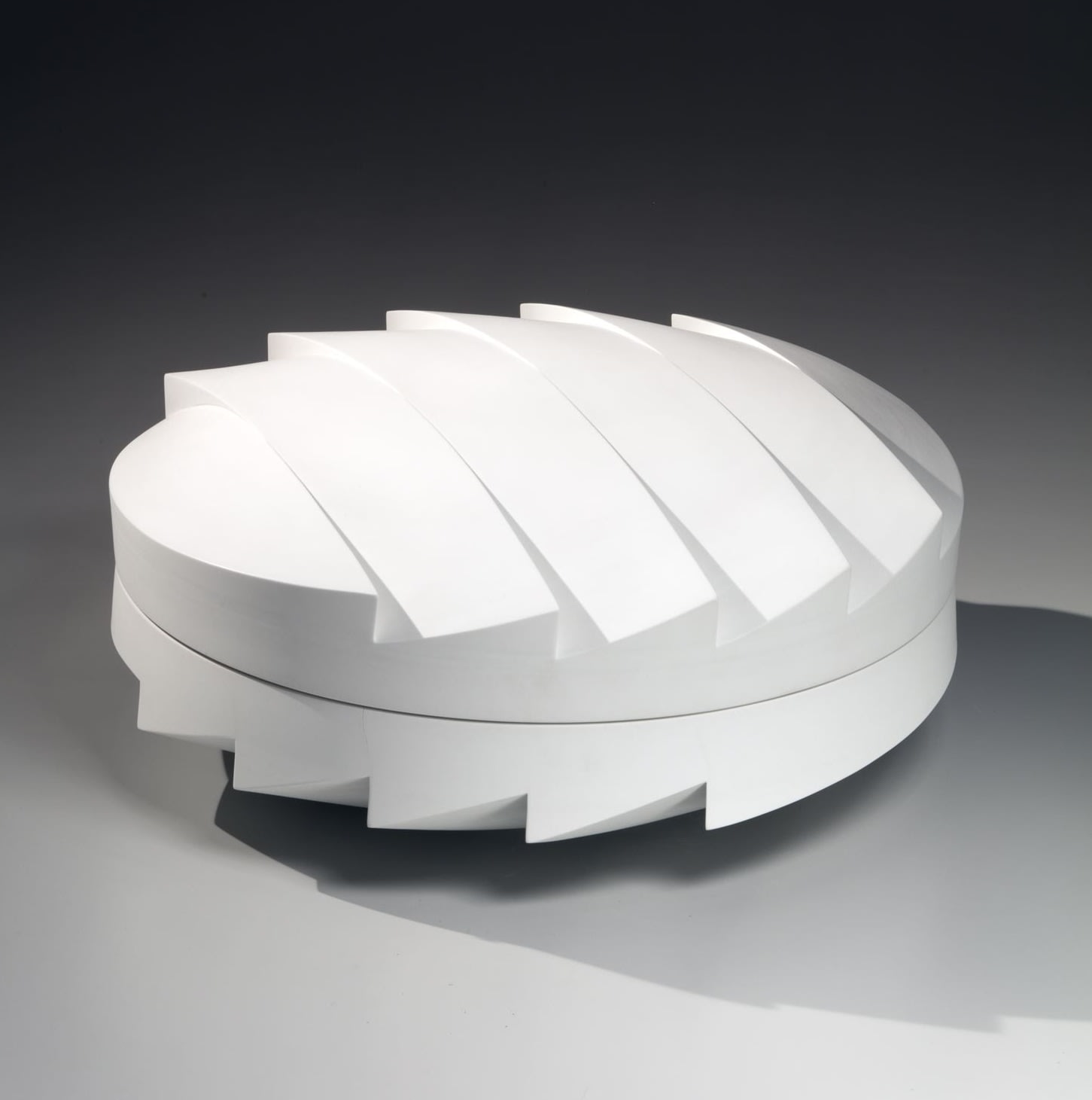 Carved circular covered box with zig-zag faceted base and cover, 2017