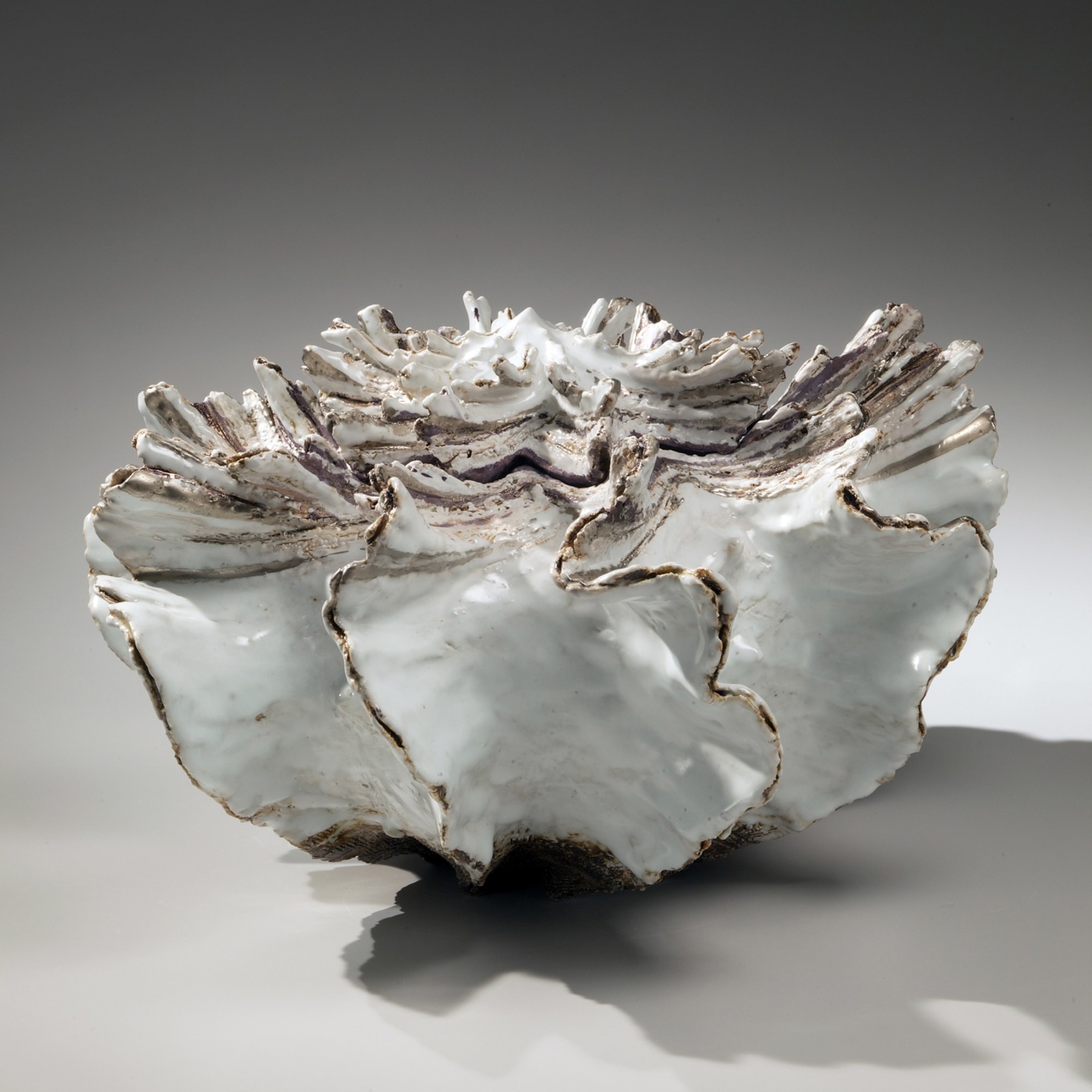 Low pleated shell-shaped covered vessel with streaked top, silver glaze along the flaring edges, white-glazed interior and purple-glazed interior rim, 2011