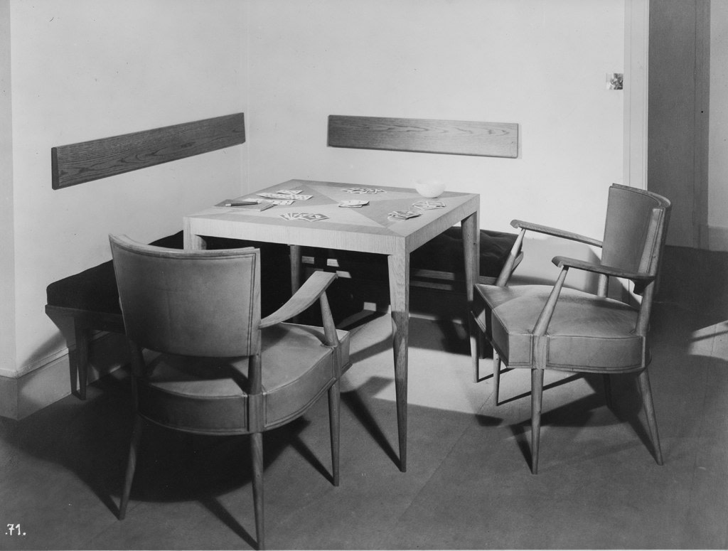 Archival image of the table installed in an apartment with gaming and chairs.