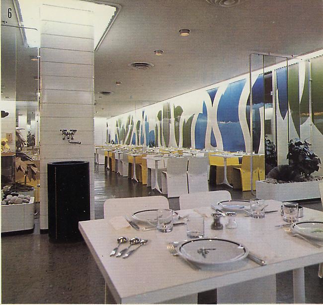 Archival image of Rothschild Bank cafeteria, featuring an original mural by Guy de Rougemont and molded fiberglass chairs by Michel Boyer.