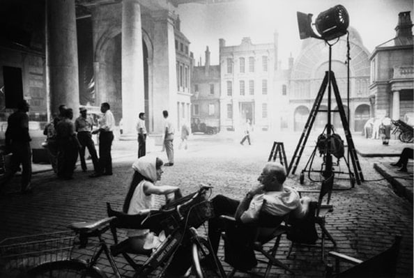 Audrey Hepburn &amp; George Cukor chat after filming has finished for the day, on the Covent Garden set of My Fair Lady, 1963