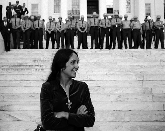 Joan Baez, folk singer, in front of State Troopers, Montgomery Alabama State House. Conclusion of Selma To Montgomery Alabama Civil Rights March, March 25, 1965