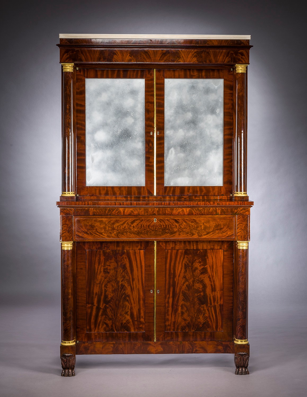 Cabinet with Mirrored Doors, about 1820. Attributed to Duncan Phyfe (1770&ndash;1854), New York. Mahogany, with ormolu capitals and bases, gilt-brass door moldings, keyhole liners, and knobs, marble, and mirror plate 78 5/8 in. high, 35 in. wide, 22 in. deep (overall). Frontal view.