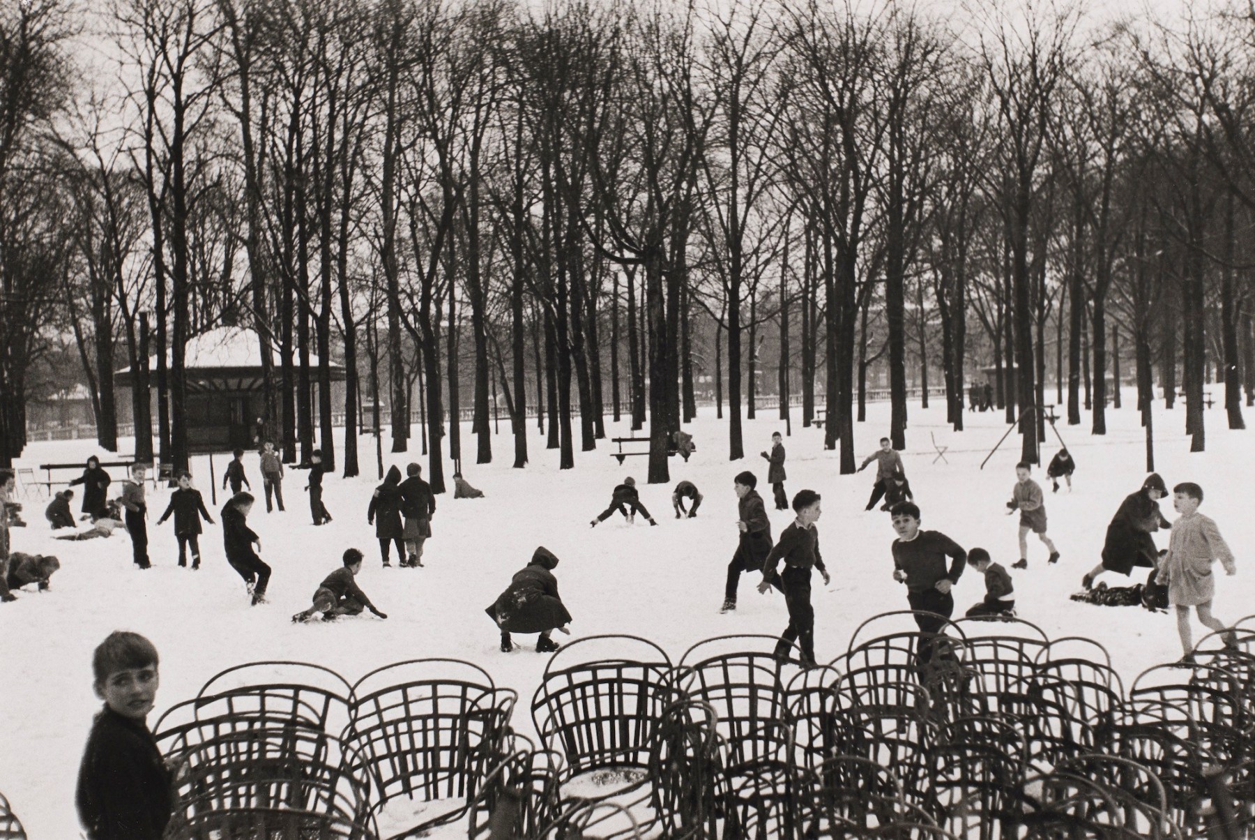 Edouard Boubat (1923-1999)  Enfants dans le Premiere Neige, 1953, printed later  Gelatin silver print  9 1/2h x 14 1/4w in, black and white photography