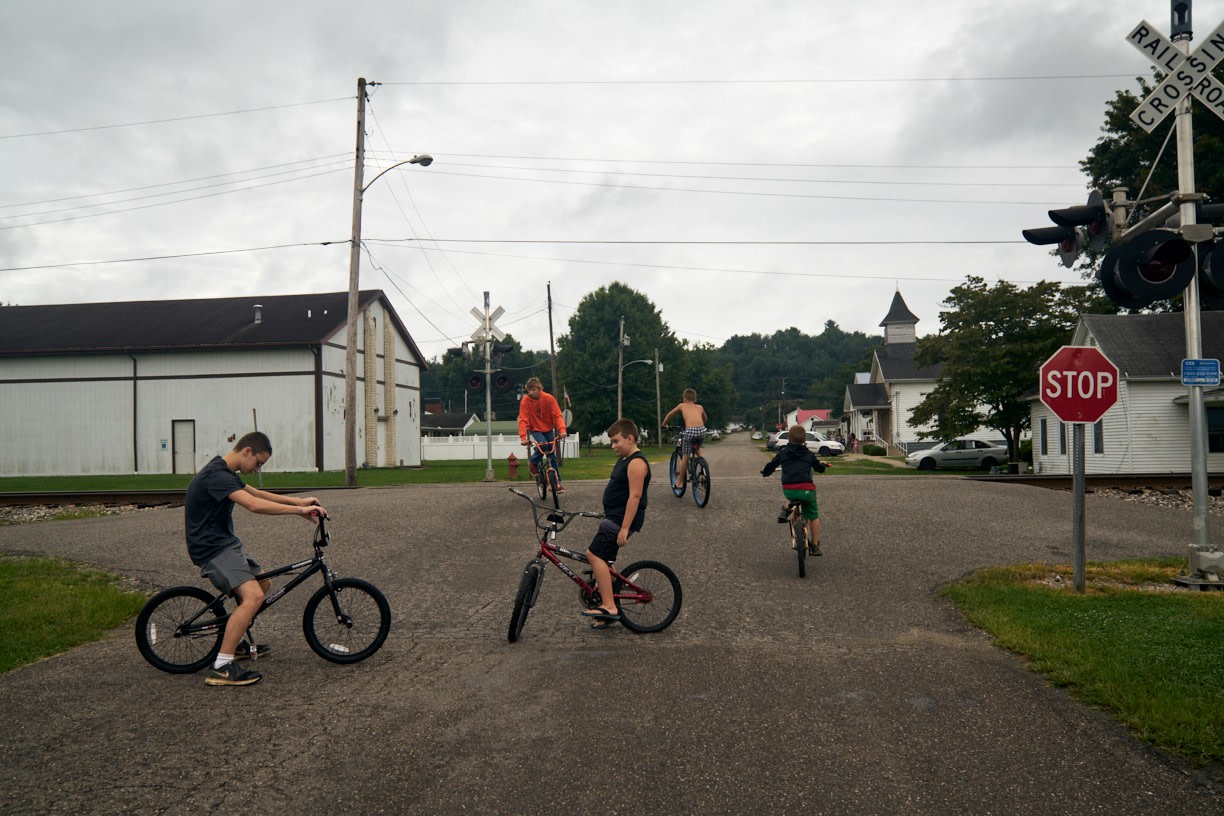 Stacy Kranitz  Mason, West Virginia, 2017  Archival Pigment Print, 16 x 24 inches, Edition of 7  20 x 30 inches, Edition of 3, Group of kids on bikes, WV