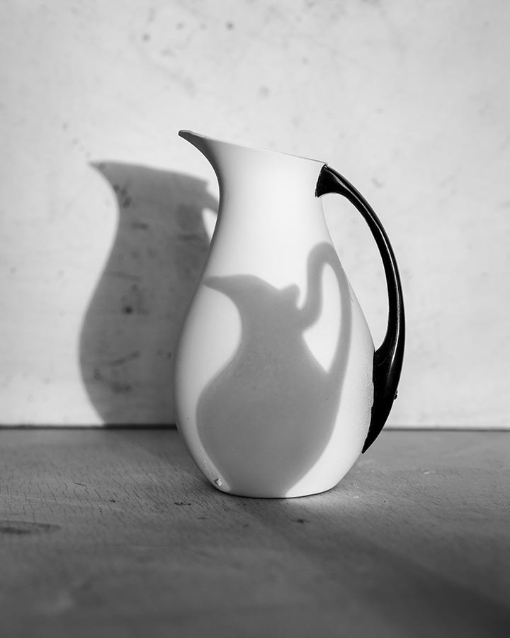 Black and white photograph of pitcher with shadow, by James Henkel