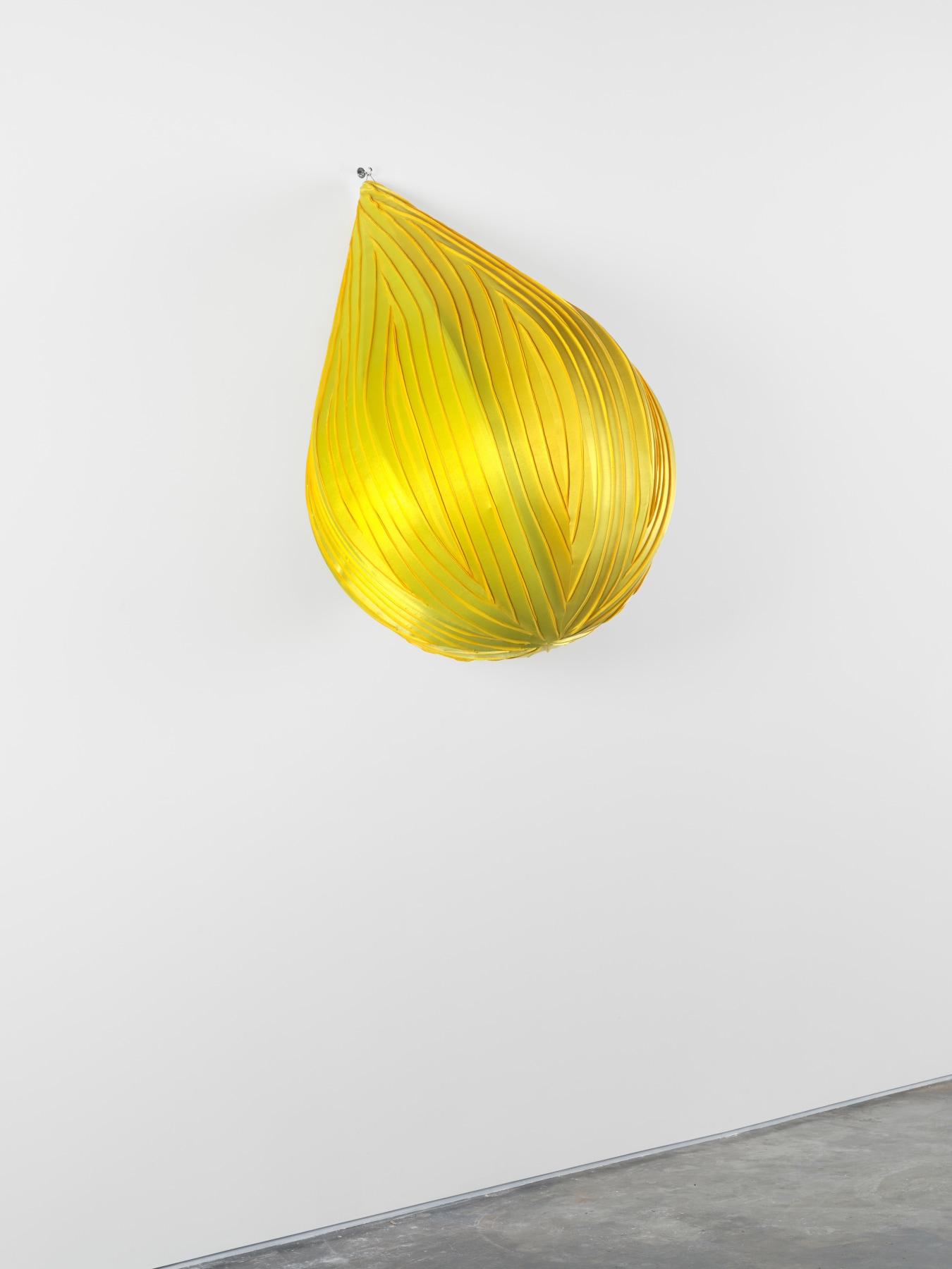 Anthony Olubunmi Akinbola artwork titled "Lemon Drop". Yellow durags stretched and sewn together over tear drop shape. 72 x 48 x 48 in (182.9 x 121.9 x 121.9 cm), durags on wood frame, 2023.