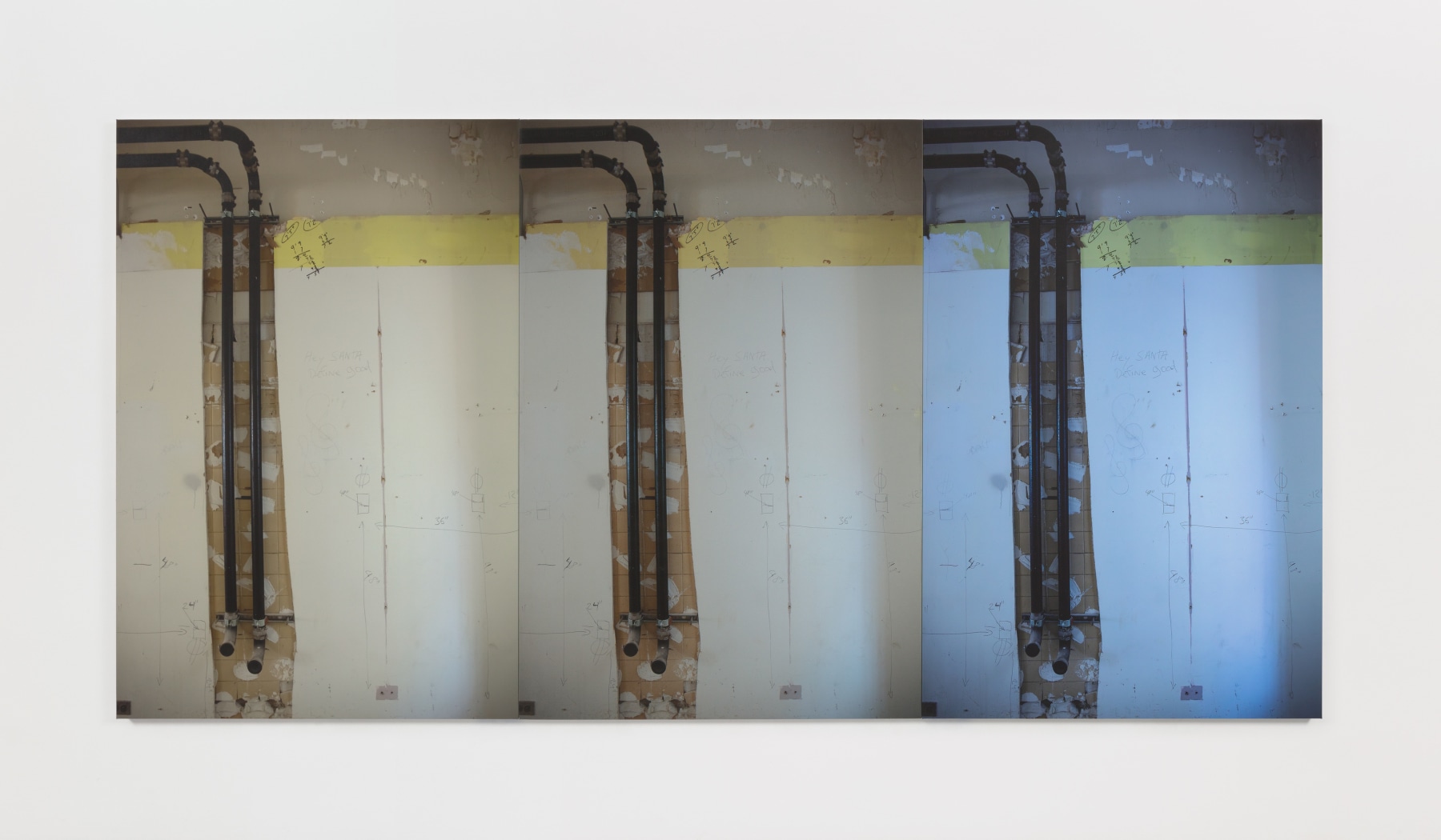 A photograph of exposed pipes in a wall surrounding by written demolition plans and graffiti repeated three times with different exposure.