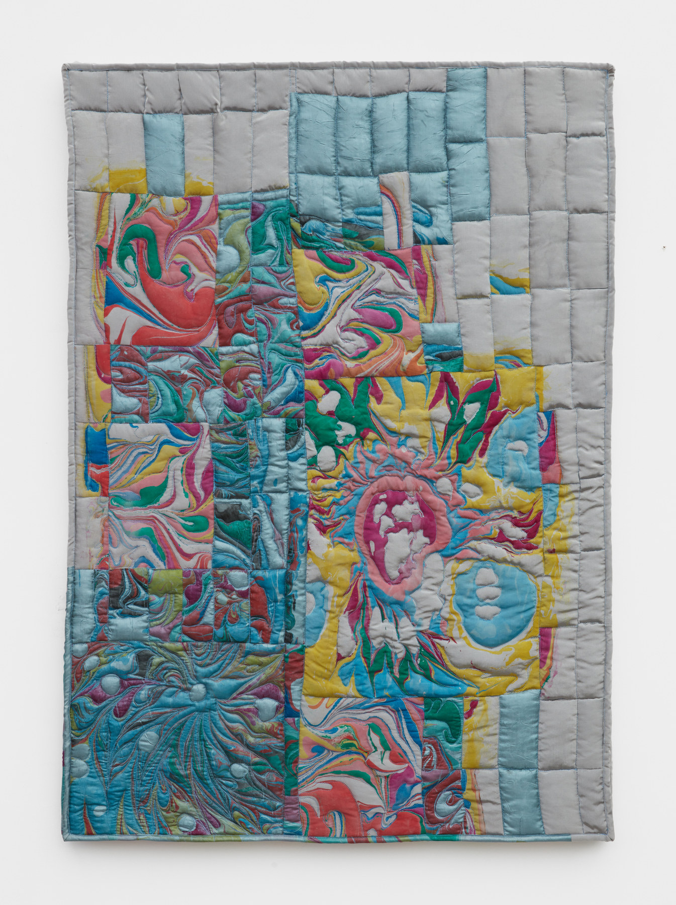 Libby Rosen's artwork "Oceania". Light greys, pinks and blues swirl in abstract shapes in a sewn textile grid. 41 x 30 in (104.1 x 76.2 cm), acrylic, satin, and batting, 2022.