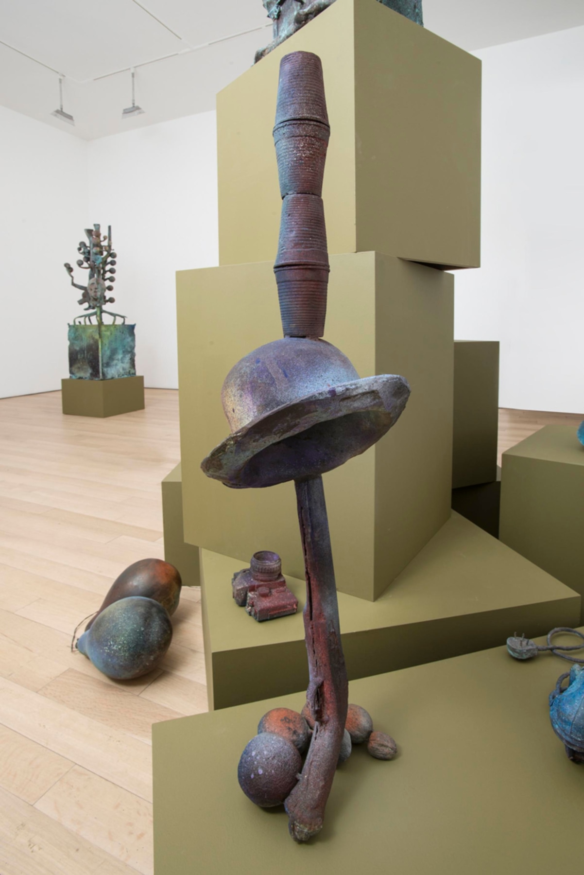 sculpture of a hat, musket, and cups balancing on each other