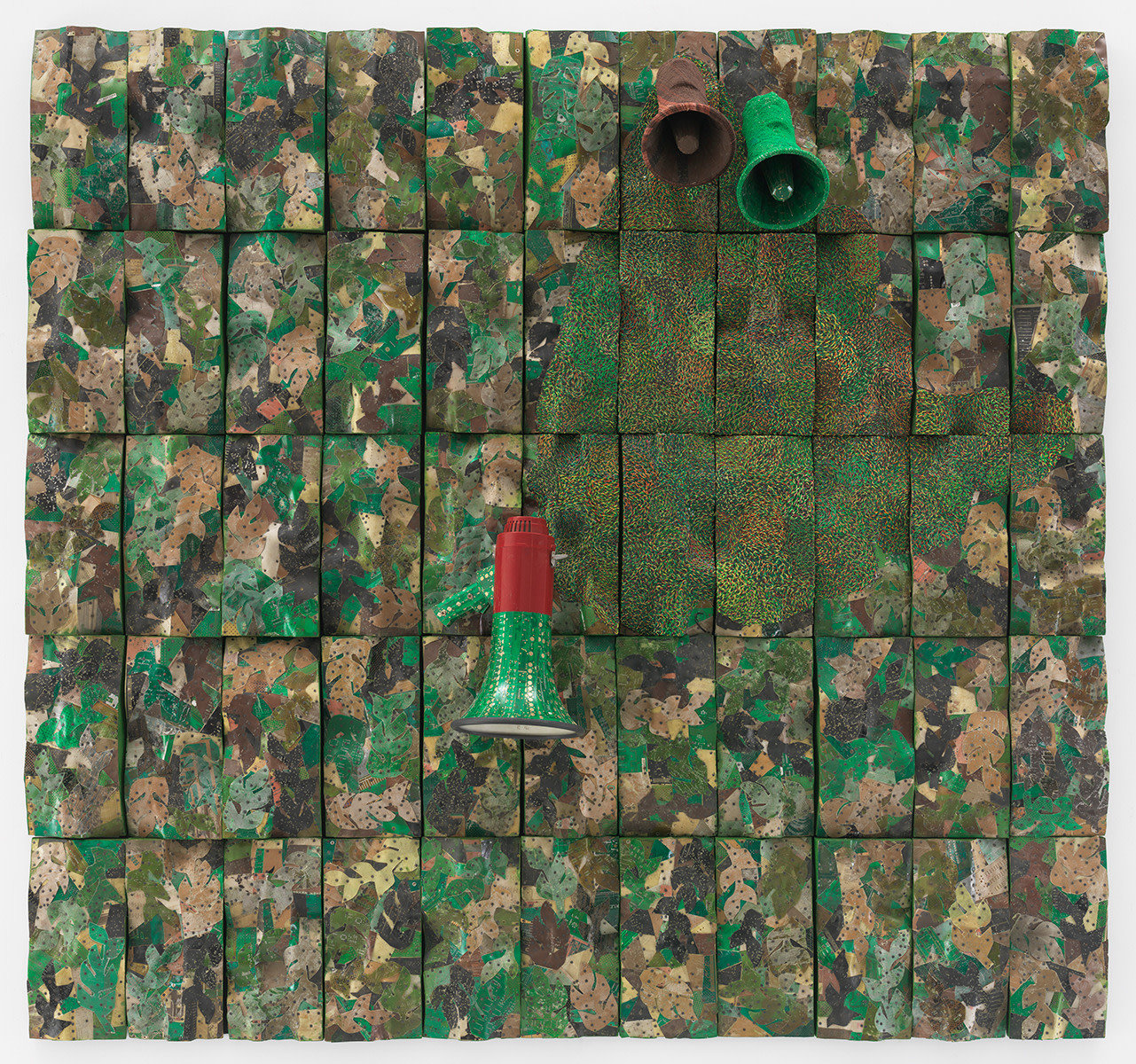 three megaphones emerging from reclaimed electrical components on a panel with a camouflage type of color and pattern