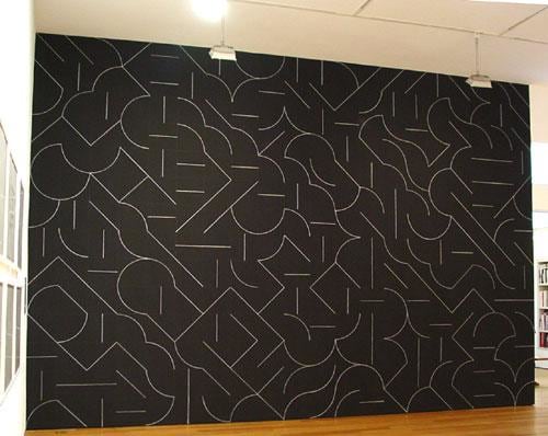abstract, linear shapes on a black wall