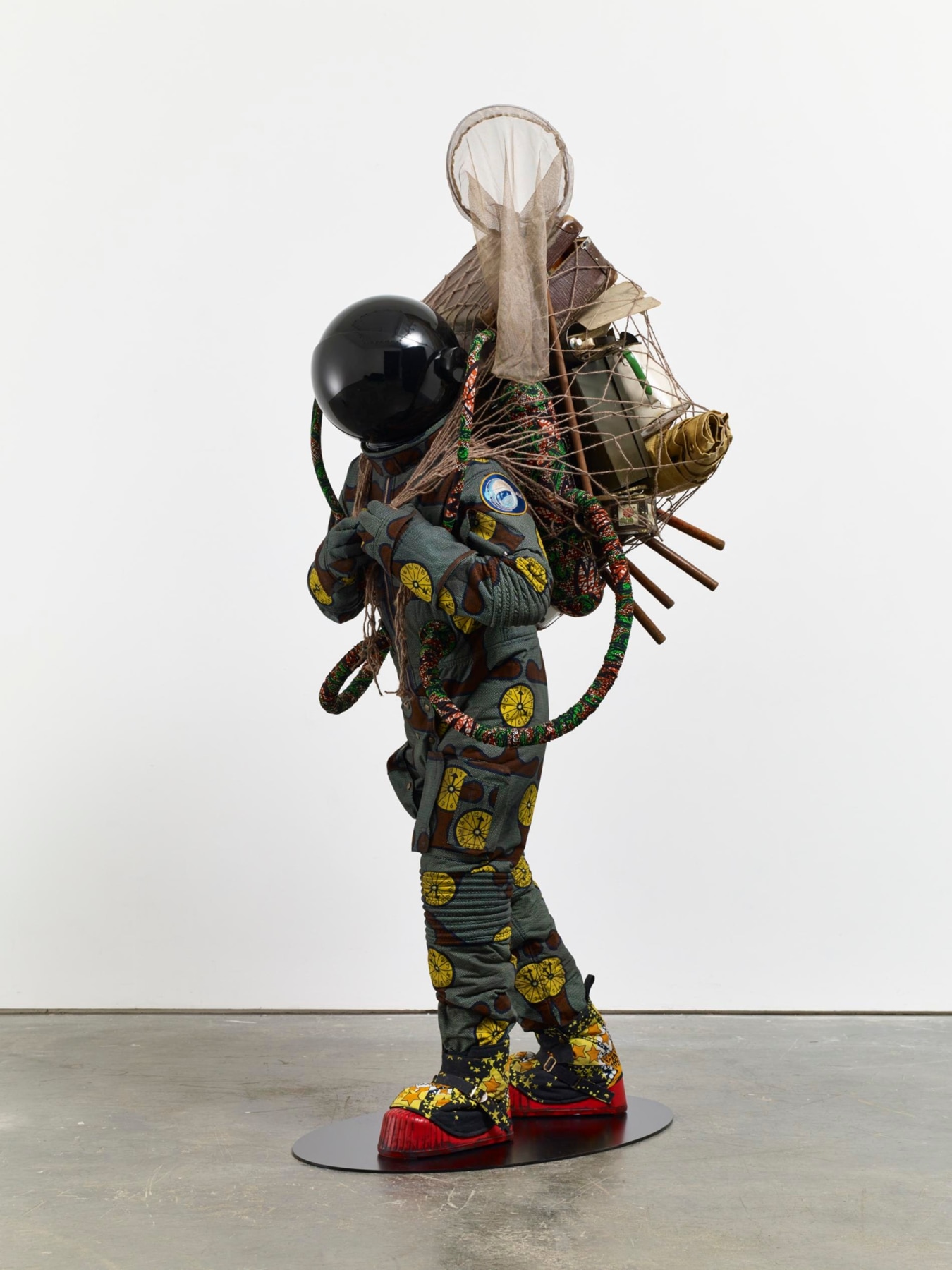 astronaut carrying a fishnet with miscellaneous objects