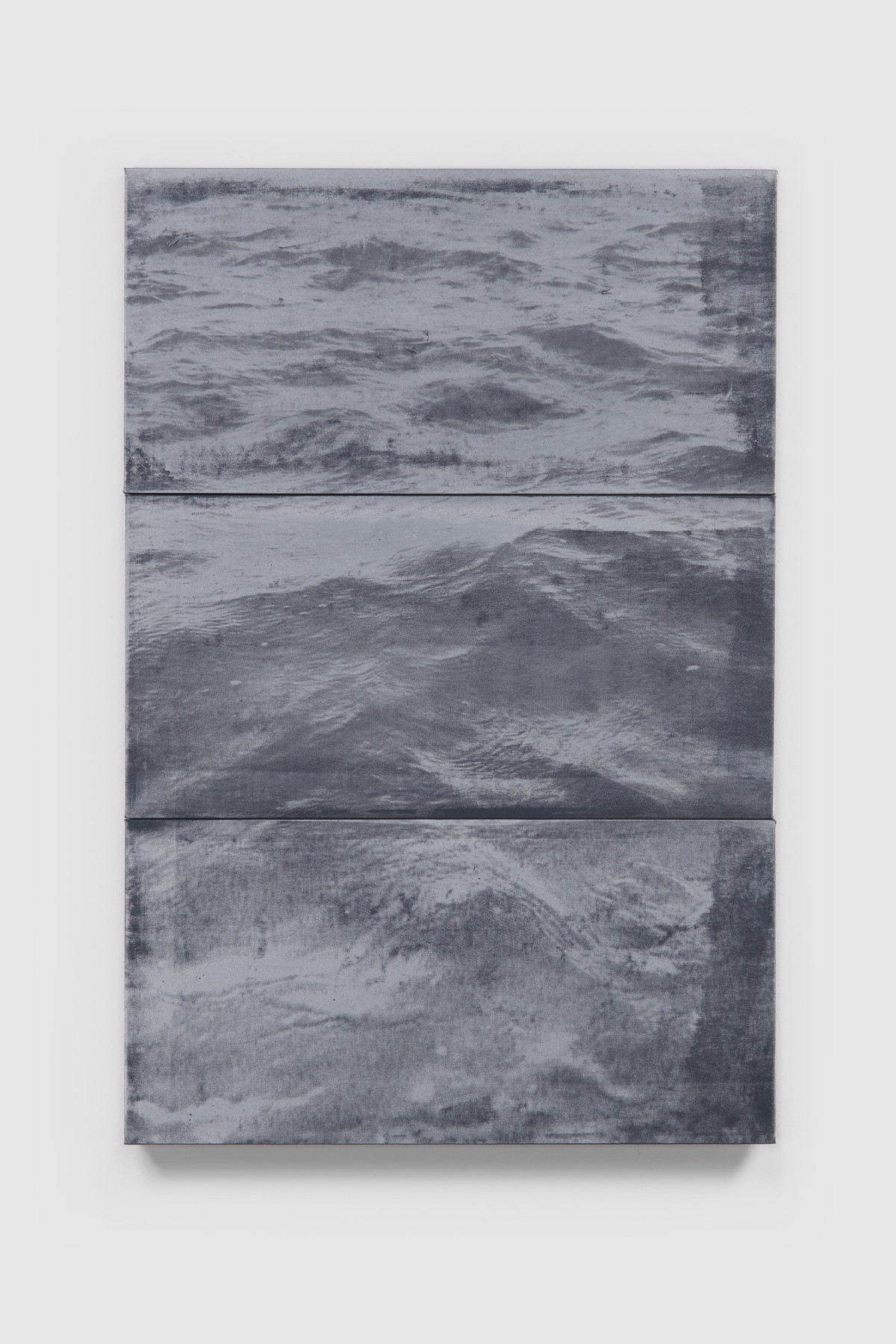 Three depictions of ocean in black and white tones