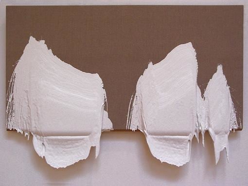 dried, white paint hanging from a canvas