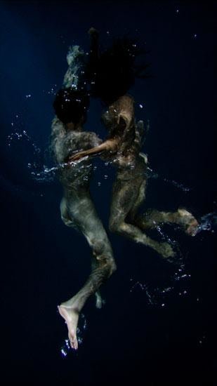 two people submerged in water