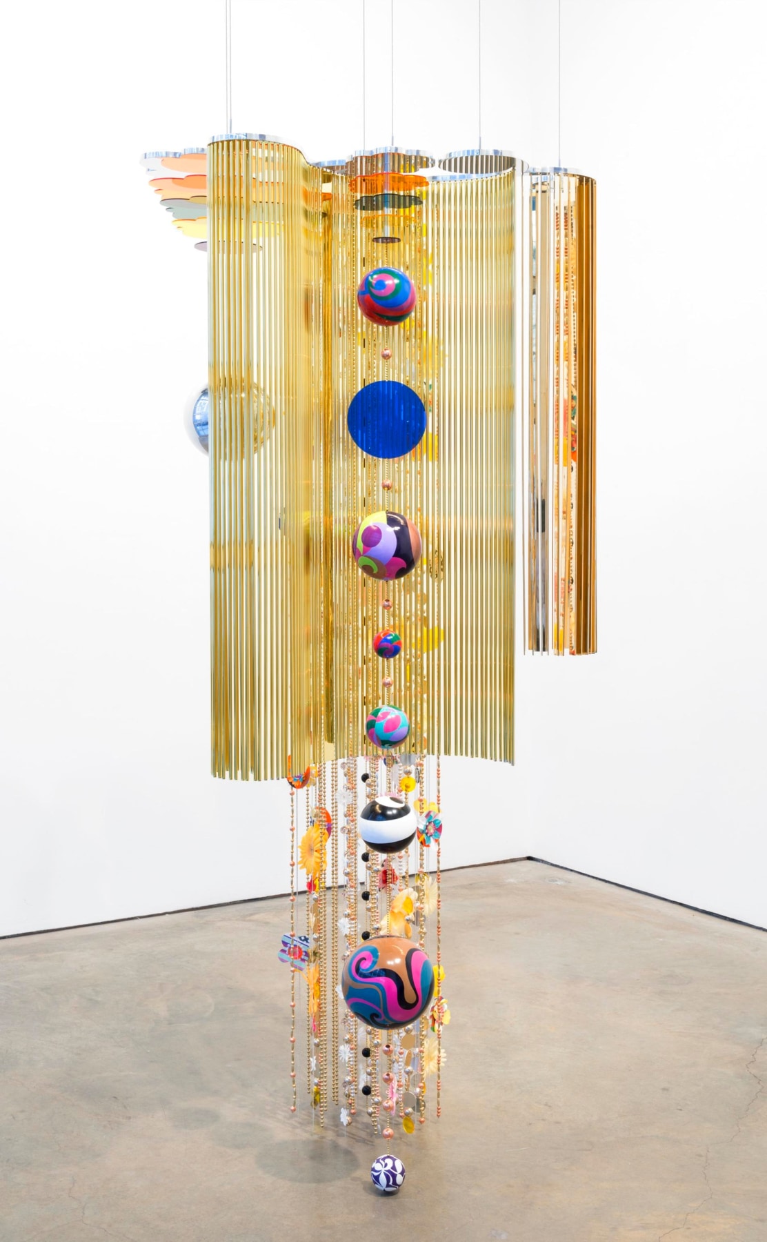 hanging sculpture with yellow strings and multicolor orbs