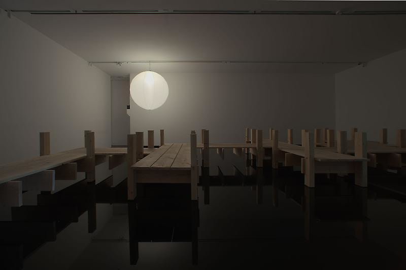 Water, wood, balloon light in a white room