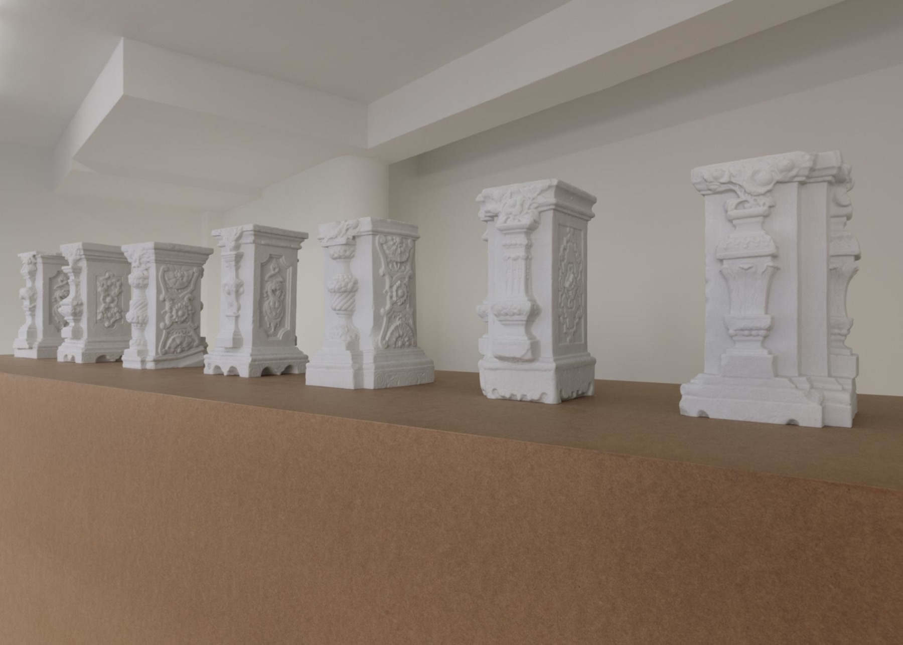 small, white intricately decorated columns