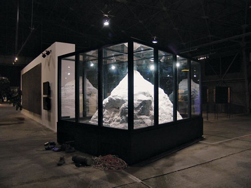 An image of an installation of white rock-like material within a black enclosed cage