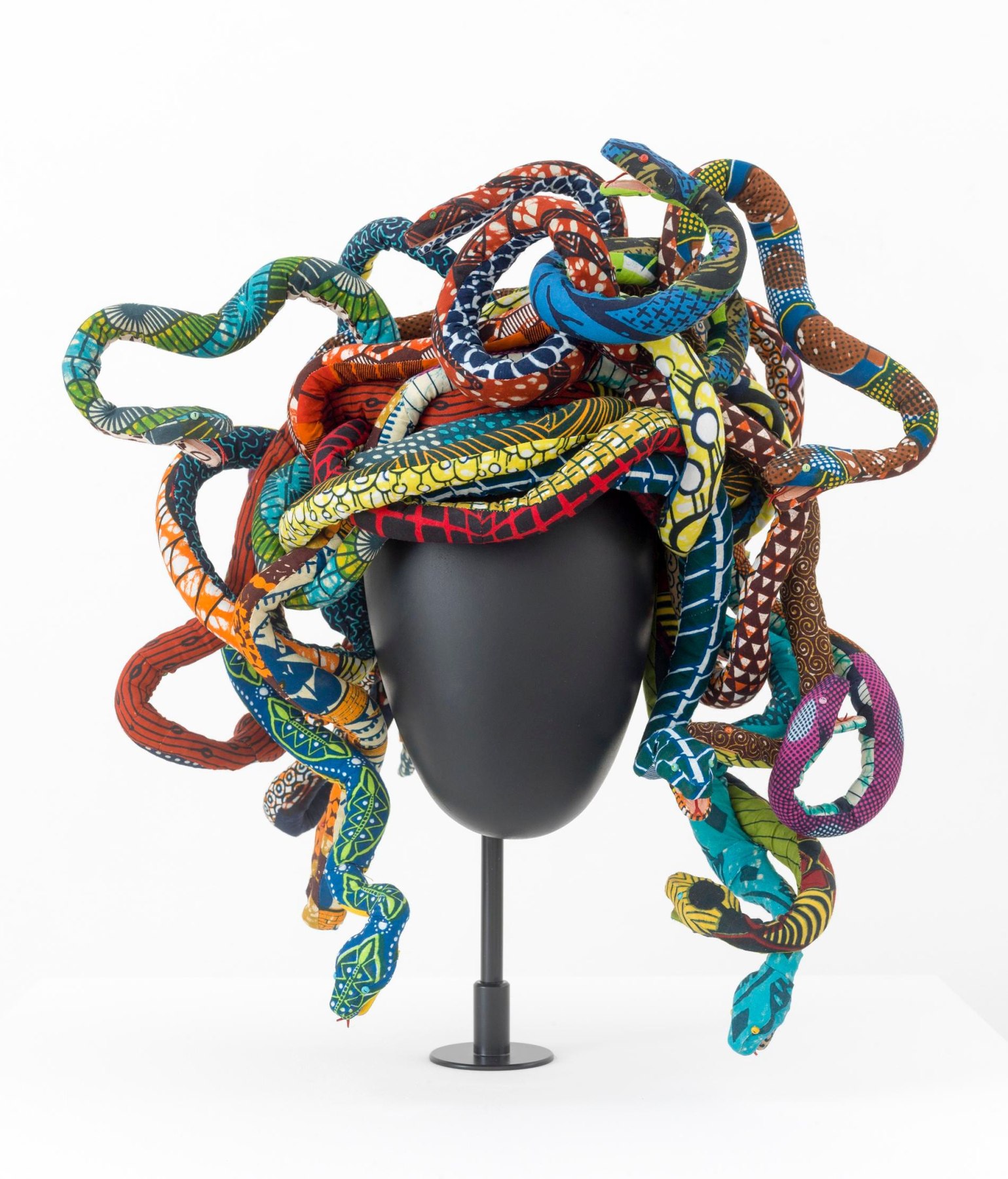 Medusa headpiece made up of many colorful snakes