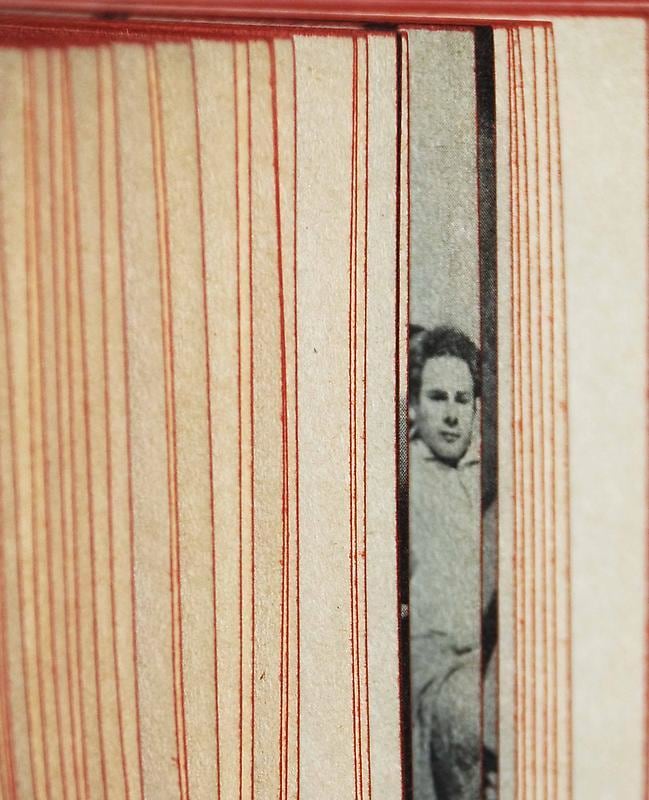 flipping book pages revealing the face of a man in between