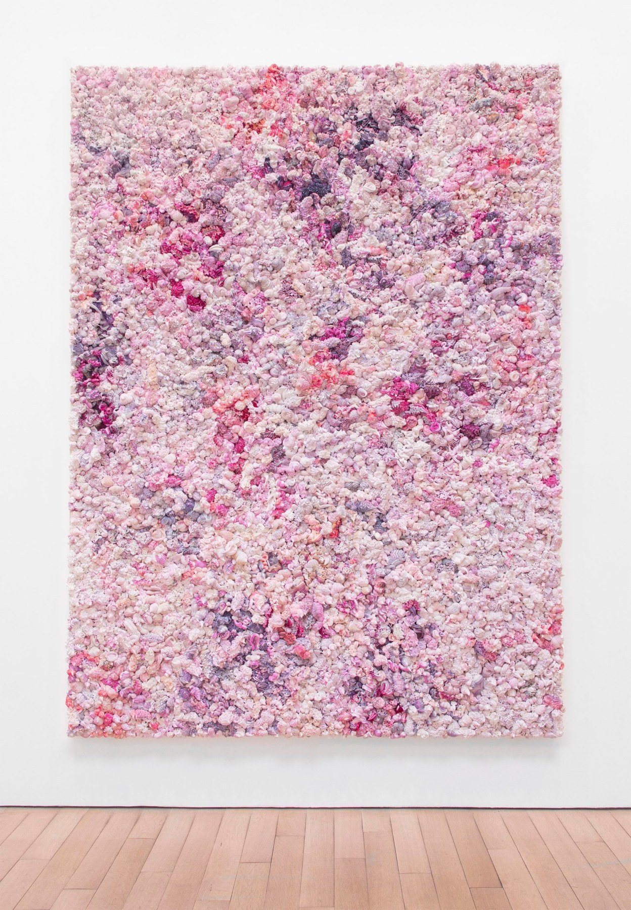 A series of pink, purple, white and red whipped-cream-like dollops made of oil paint on canvas