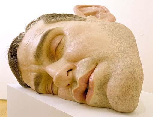 giant realistic head of a man laying on its side