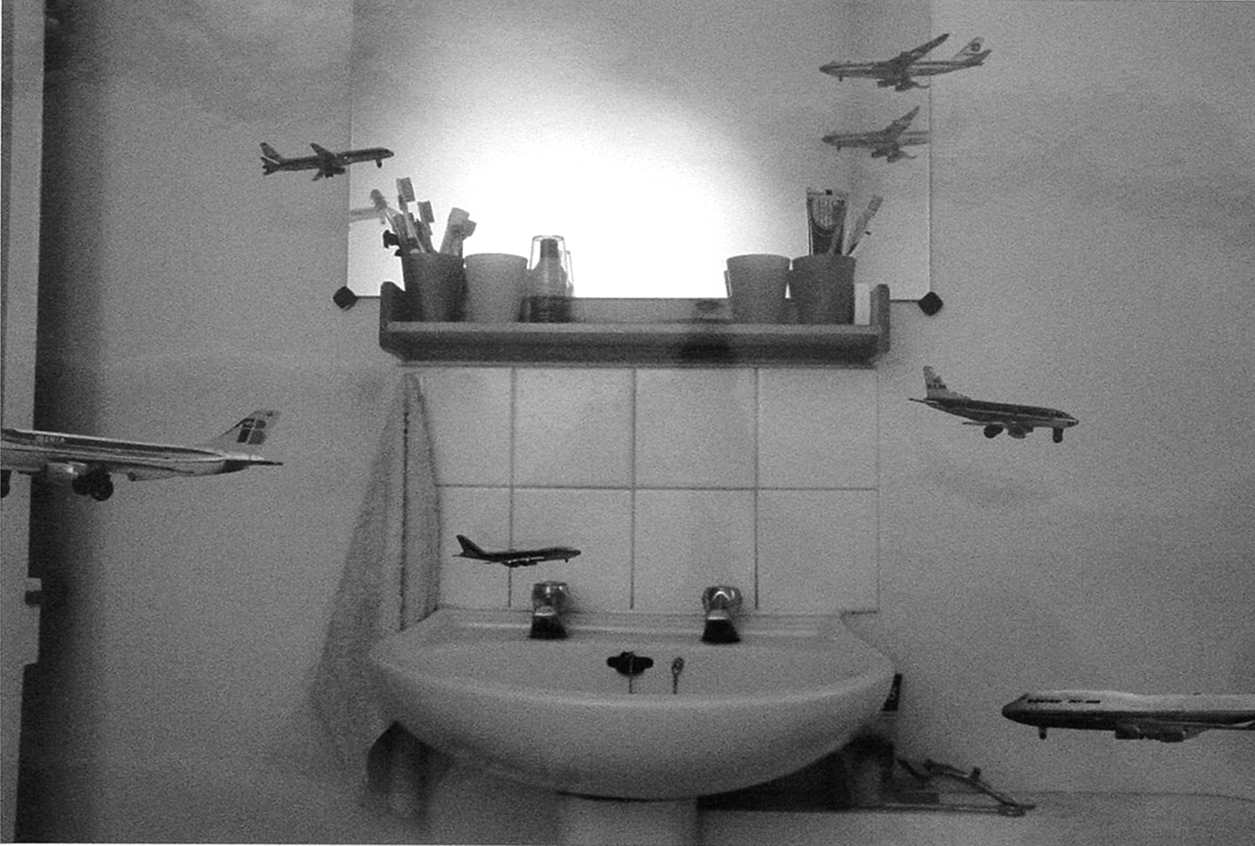 miniature airplanes flying around a bathroom