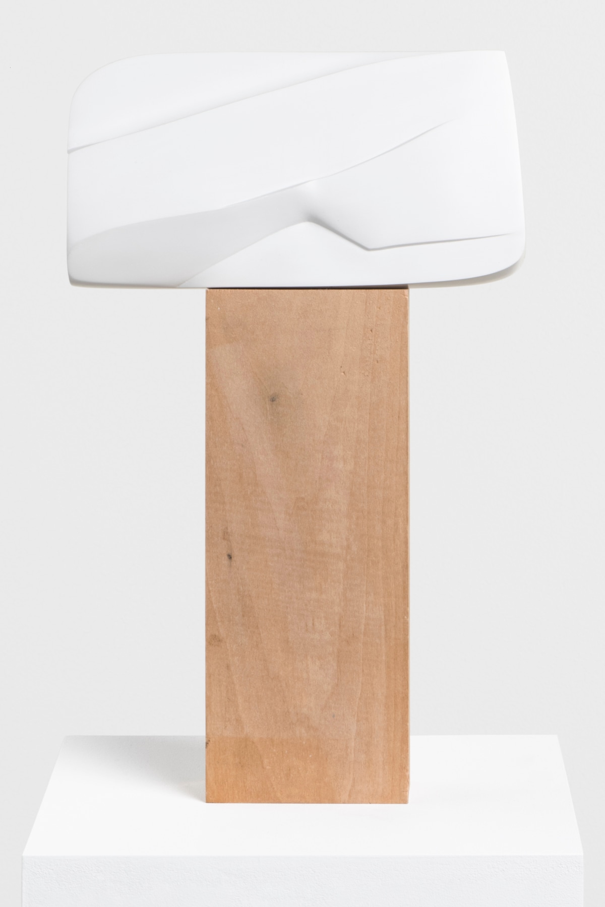 wooden, rectangular block balancing a white cube